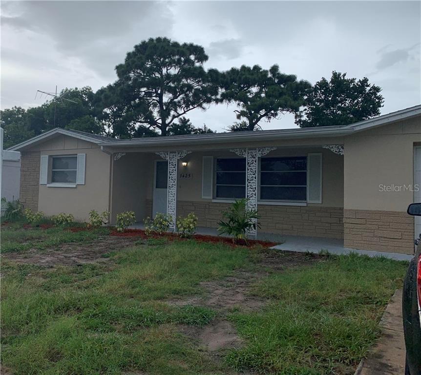 7425 Seashore Drive Port Richey, FL 34668 - Photo 1 of 1 a front view of a house with garden
