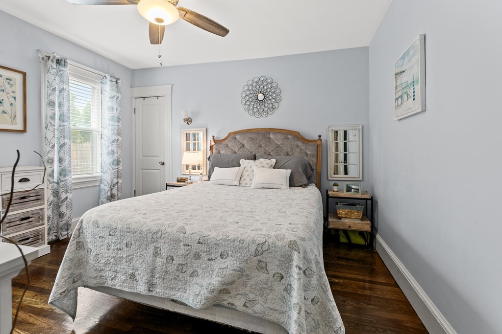 182 Court Road, Unit 1 Winthrop, MA 02152 - Photo 11 of 16 a bedroom with a bed and a chandelier