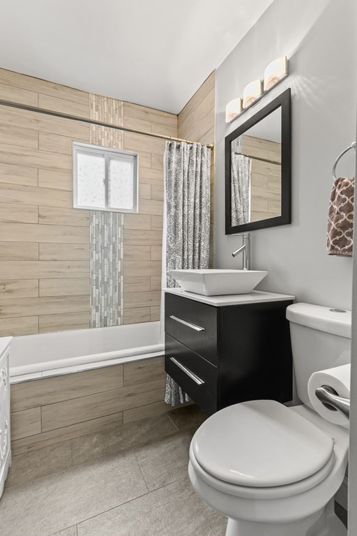 182 Court Road, Unit 1 Winthrop, MA 02152 - Photo 12 of 16 a bathroom with a toilet a sink and mirror