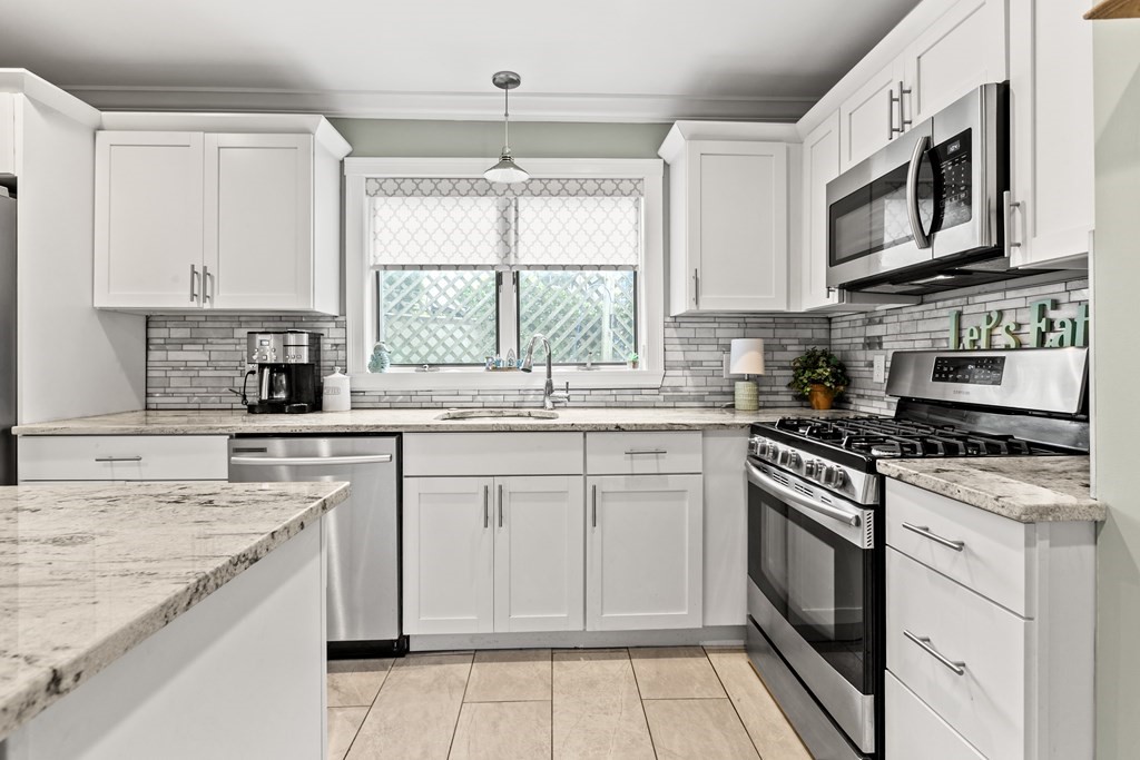 182 Court Road, Unit 1 Winthrop, MA 02152 - Photo 16 of 16 a kitchen with stainless steel appliances granite countertop a stove a sink and a microwave