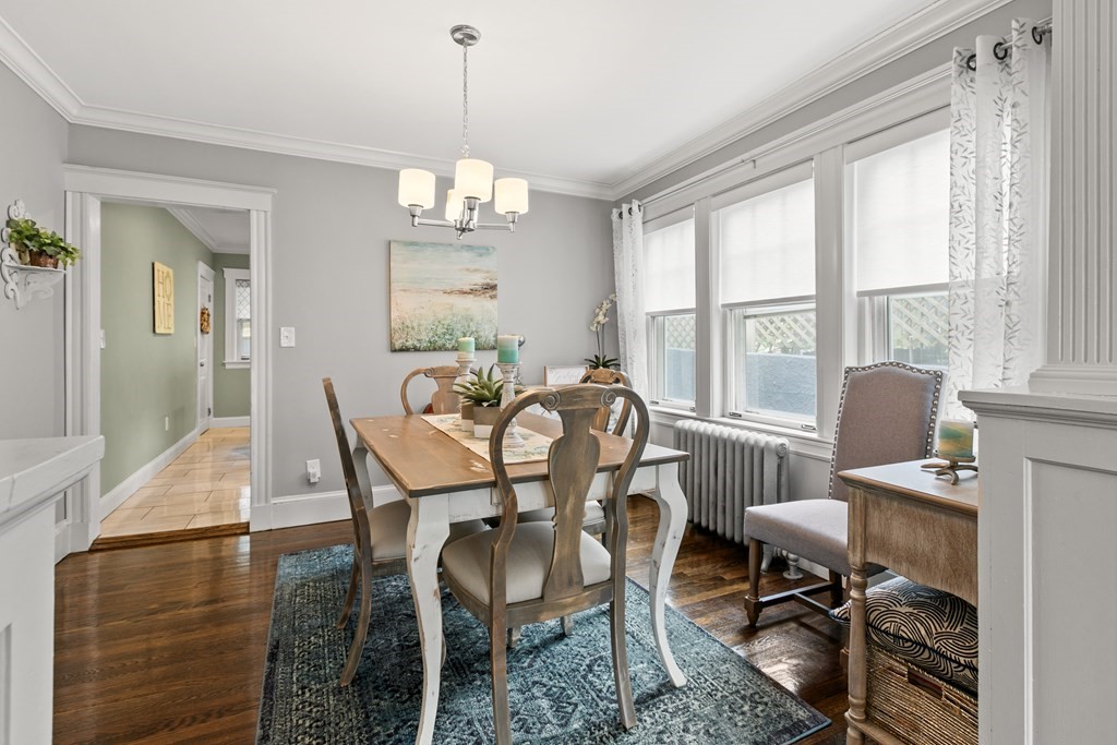 182 Court Road, Unit 1 Winthrop, MA 02152 - Photo 8 of 16 a dining room with furniture a chandelier and wooden floor