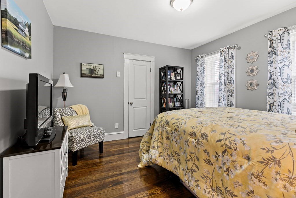 182 Court Road, Unit 1 Winthrop, MA 02152 - Photo 10 of 16 a bedroom with bed and wooden floor