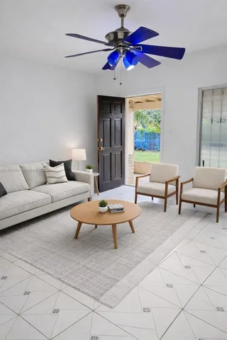 a living room with furniture a chandelier and a window