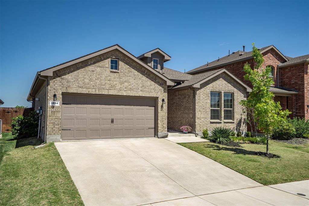 1864 Mensa Drive Haslet, TX 76052 - Photo 4 of 40 a front view of a house with a yard and garage