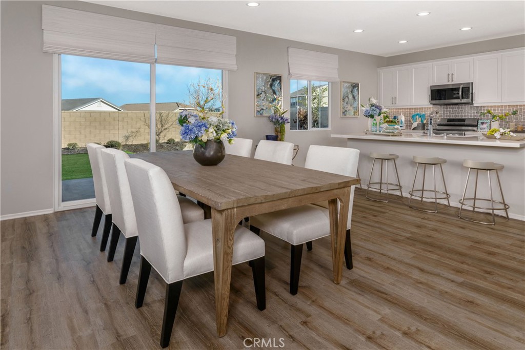 9075 Carson Avenue Hesperia, CA 92344 - Photo 4 of 13 a dining room with furniture and wooden floor