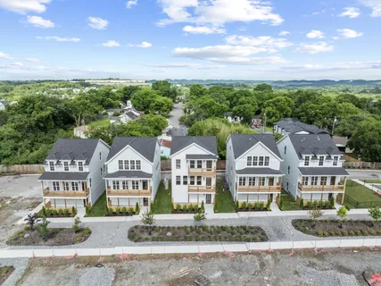 an aerial view of a house with a big yard and potted plants