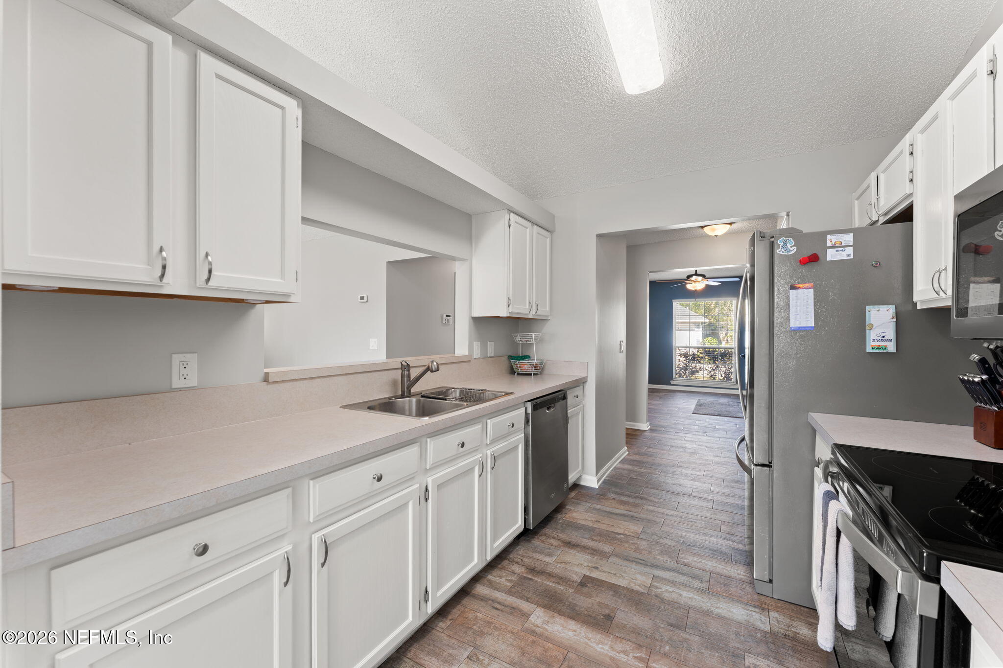 2982 Chief Ridaught Trail Middleburg, FL 32068 - Photo 7 of 29 a kitchen with white cabinets sink and stove