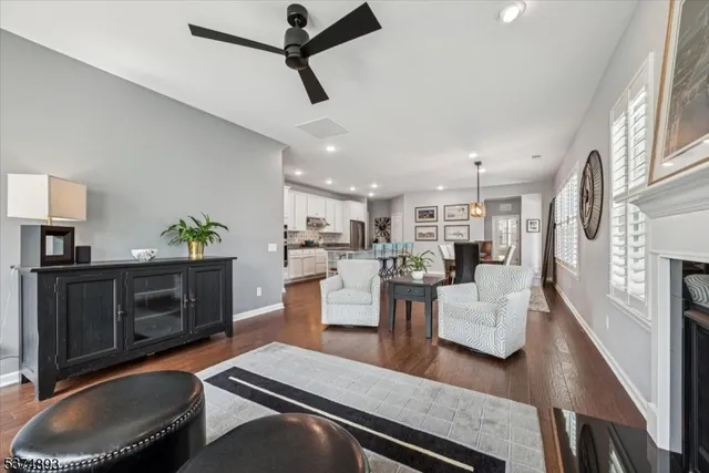 a living room with furniture and a kitchen view