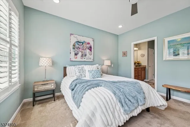 a bedroom with a bed and a painting on the wall