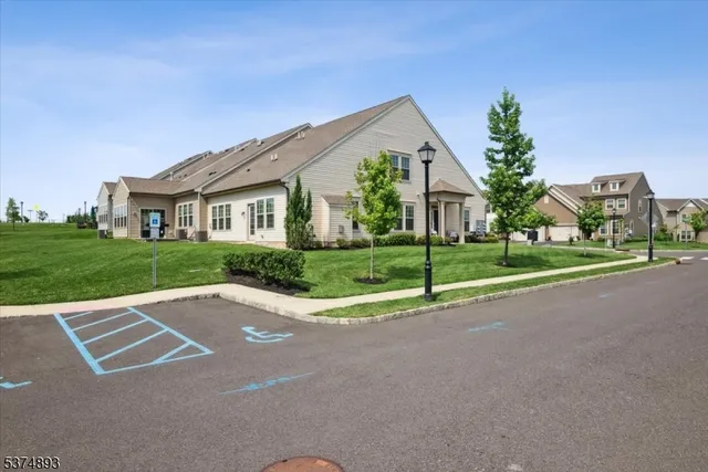 a view of a house with a big yard and palm trees