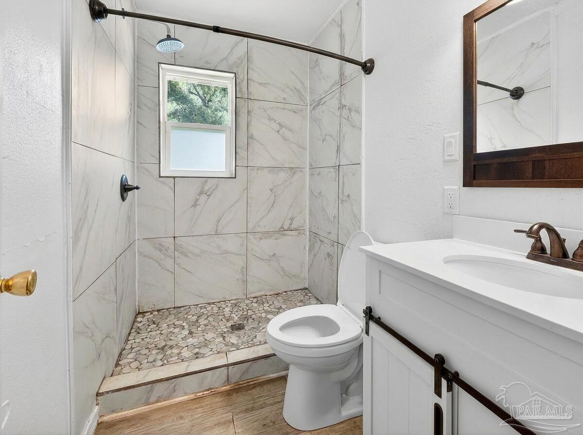 6253 Allentown Road Milton, FL 32570 - Photo 11 of 31 a bathroom with a sink a toilet and shower