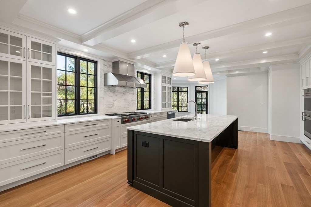 31 Cranmore Road Wellesley, MA 02481 - Photo 8 of 42 a kitchen with kitchen island granite countertop a stove and a wooden floors