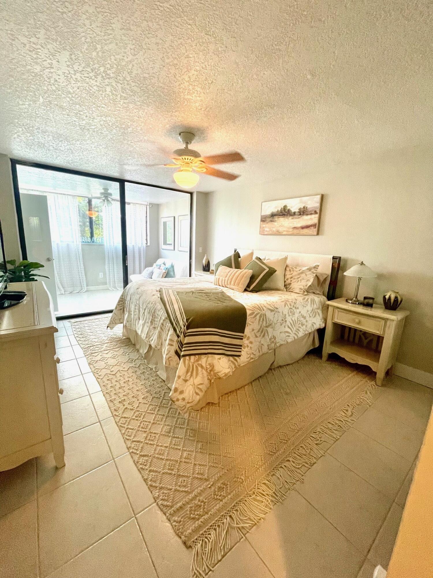 755 Dotterel Road, Unit 1312 Delray Beach, FL 33444 - Photo 11 of 21 a bed room with a bed and a night stand