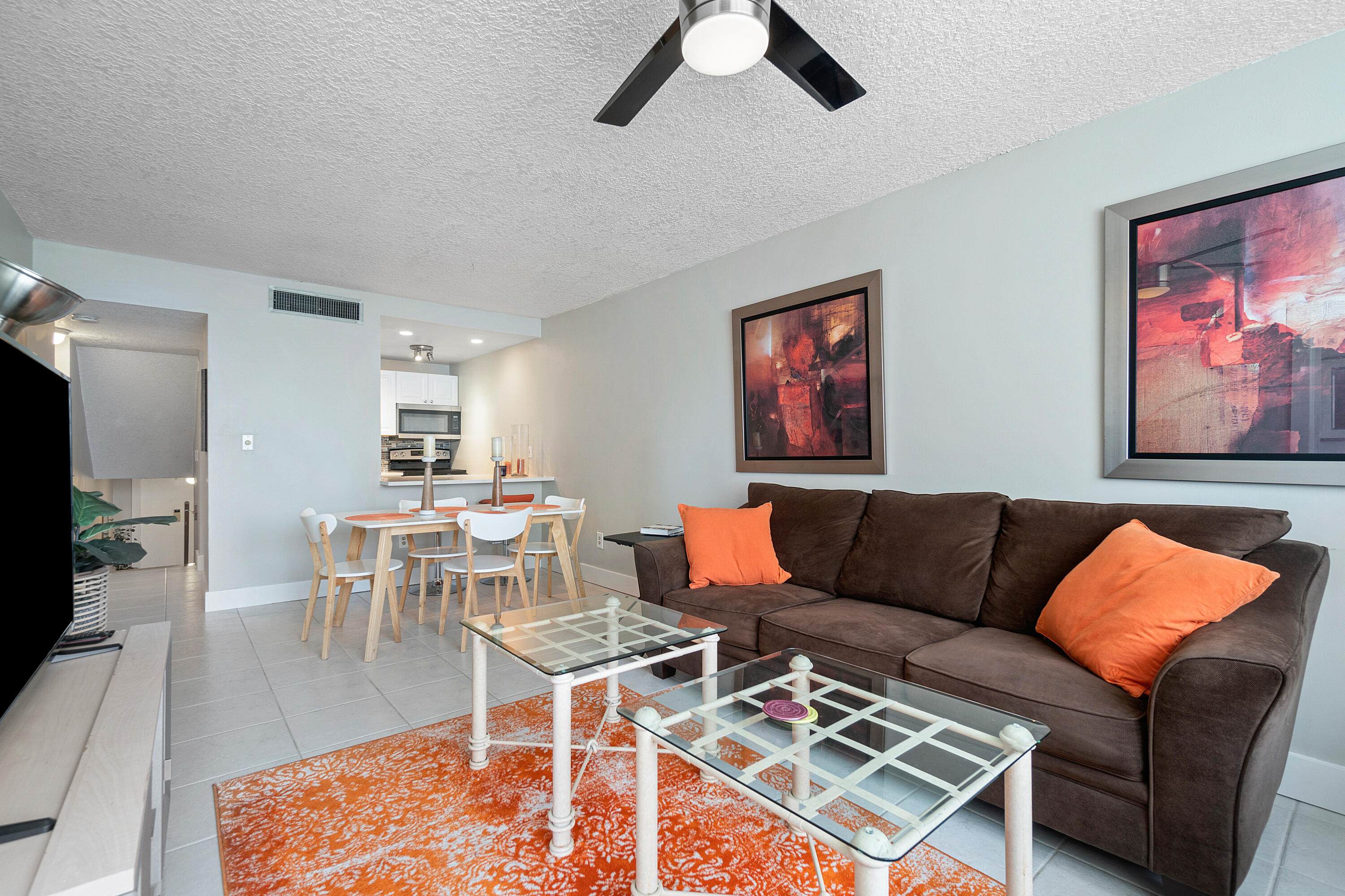 755 Dotterel Road, Unit 1312 Delray Beach, FL 33444 - Photo 5 of 21 a living room with furniture a rug and a flat screen tv