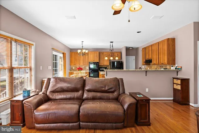 a kitchen that has a lot of white cabinets and stainless steel appliances