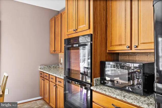 a kitchen with granite countertop a stove and a sink