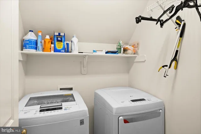 a utility room with a sink dryer and washer