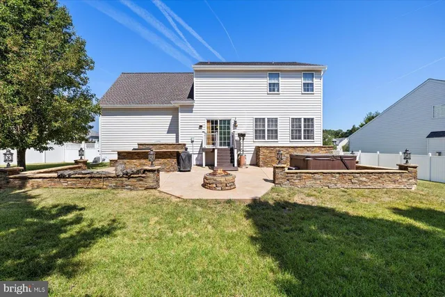 a view of a backyard with table and chairs and a fire pit