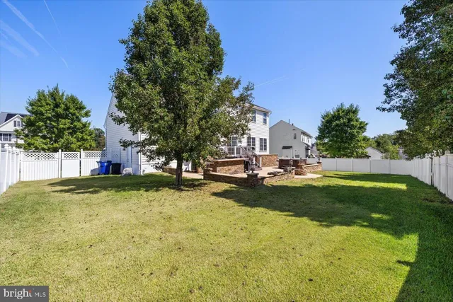 a view of a patio with table and chairs with wooden fence and plants