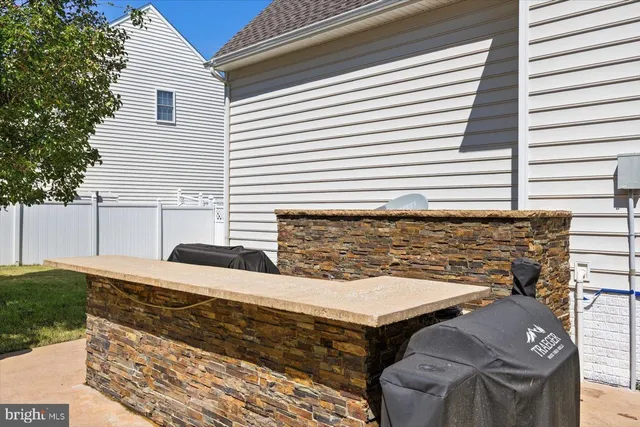 a picture of a bench in front of a gate