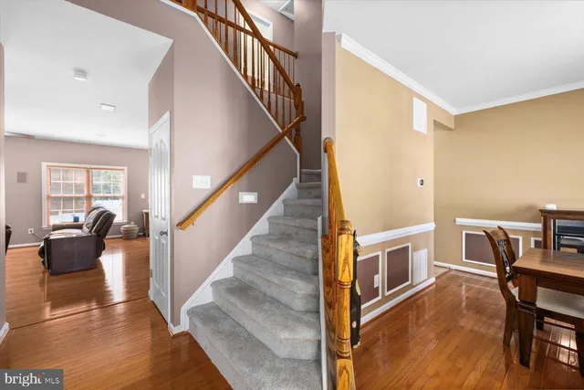 a view of livingroom with furniture workspace and stairs