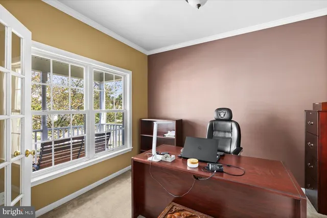 a living room with furniture a fireplace and a large window