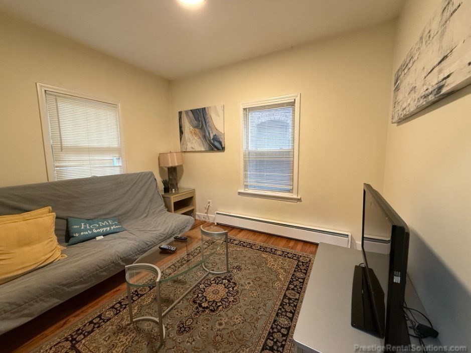 20 Pompeii Street, Unit 1 Boston, MA 02119 - Photo 1 of 7 a living room with furniture and a window