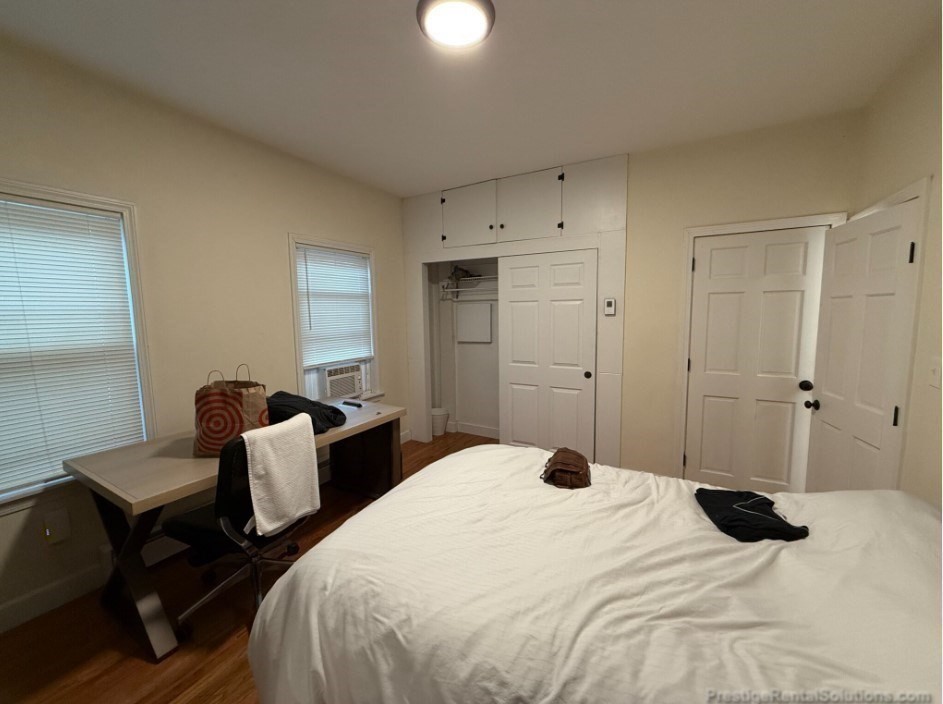 20 Pompeii Street, Unit 1 Boston, MA 02119 - Photo 3 of 7 a bedroom with a bed and a lamp