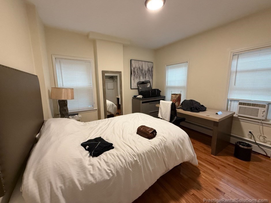 20 Pompeii Street, Unit 1 Boston, MA 02119 - Photo 4 of 7 a bedroom with a bed and wooden floor