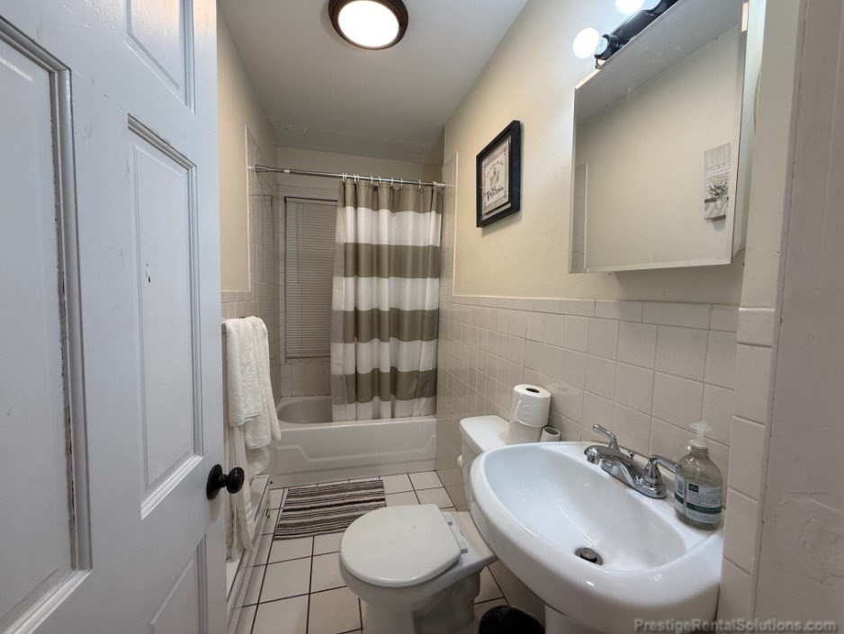 20 Pompeii Street, Unit 1 Boston, MA 02119 - Photo 5 of 7 a bathroom with a sink toilet and shower