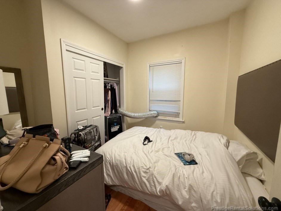 20 Pompeii Street, Unit 1 Boston, MA 02119 - Photo 6 of 7 a bed sitting in a bedroom and a mirror