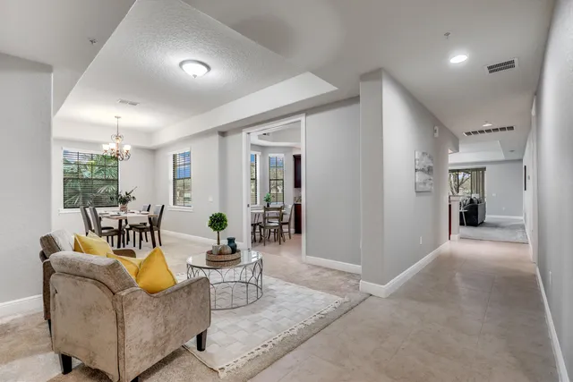 a living room with furniture and painting on the wall