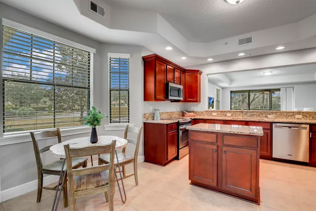 a kitchen with granite countertop a stove and cabinets