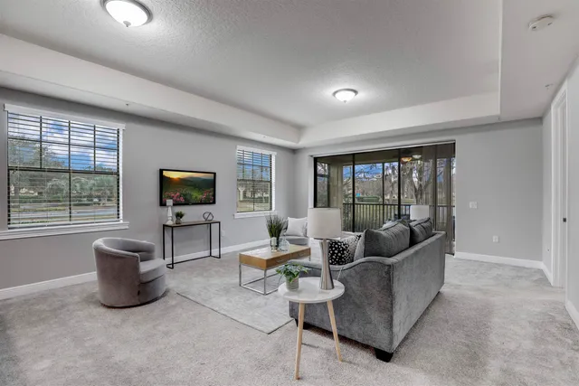 a living room with furniture and a large window