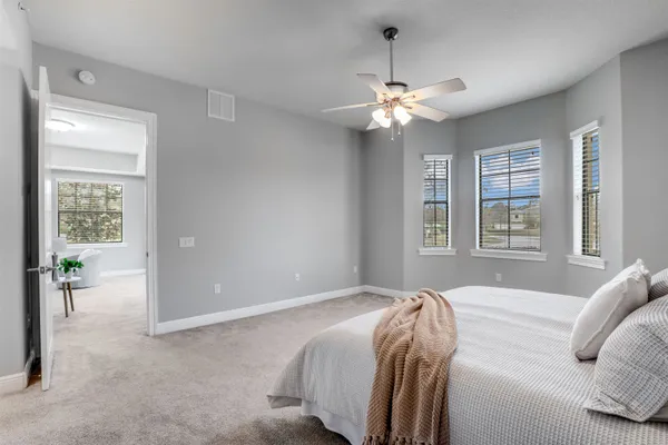 a bedroom with a bed and a chandelier