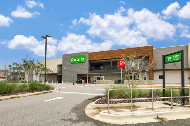 a front view of building with cars parked