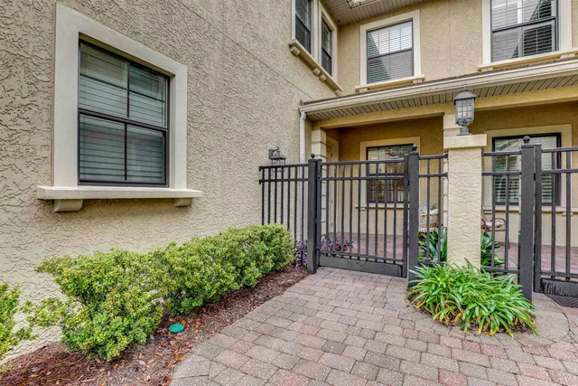 a front view of a house with a lots of flower plants