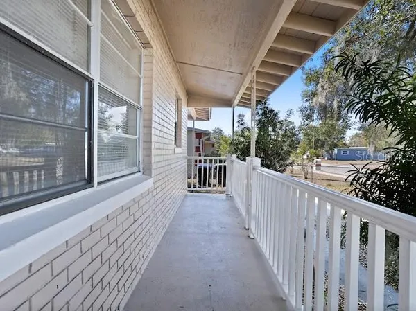 a view of a house with wooden deck