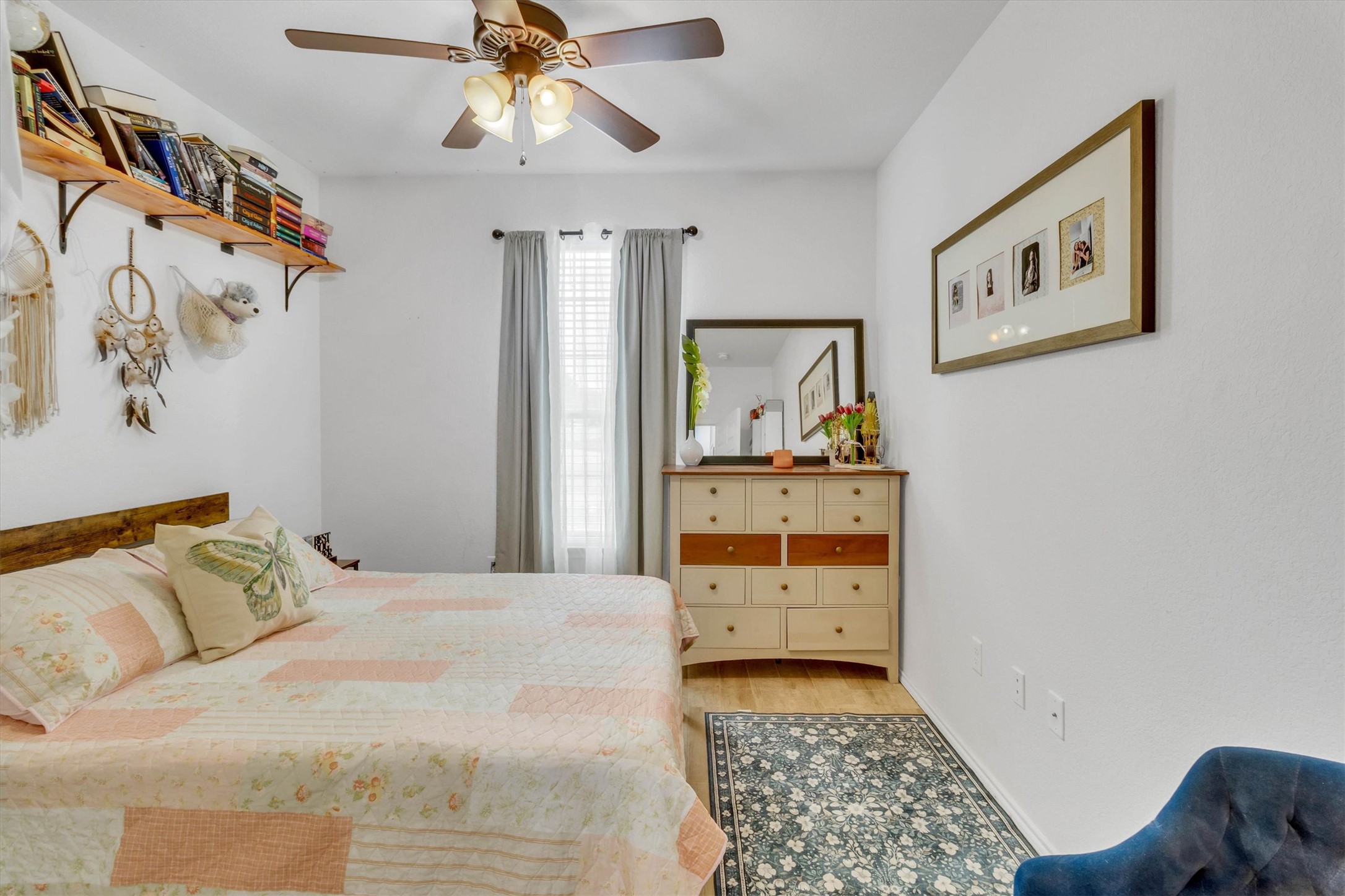 460 Waterleaf Boulevard Kyle, TX 78640 - Photo 17 of 30 Enjoy comfort in this well-lit bedroom featuring wood floors and a ceiling fan.