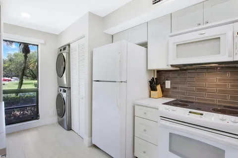 a kitchen with a refrigerator and a washing machine