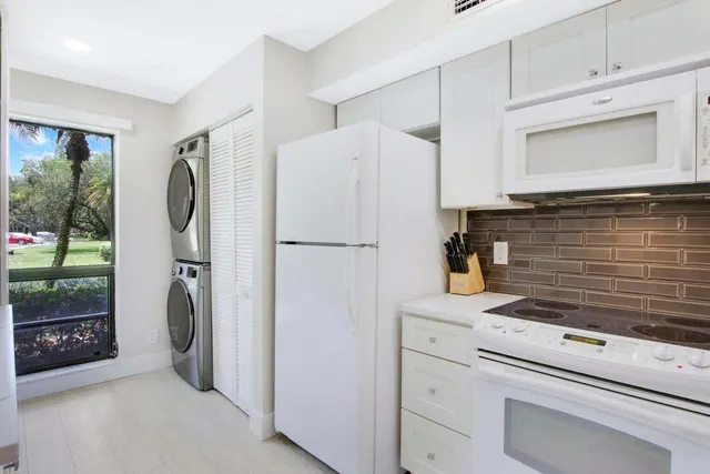 a kitchen with a refrigerator and a washing machine