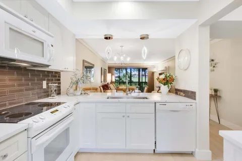 a kitchen with cabinets and window