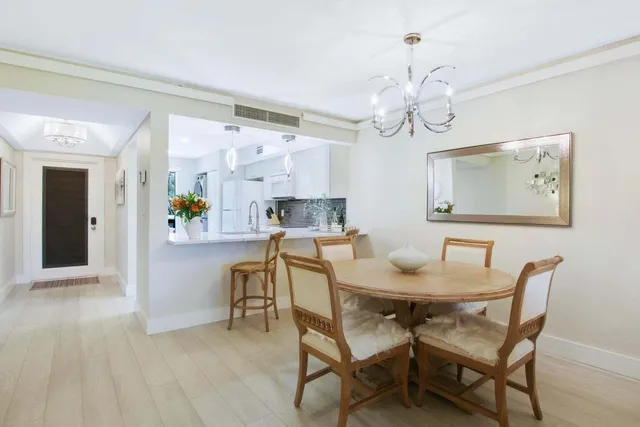a view of a dining room with furniture and a chandelier
