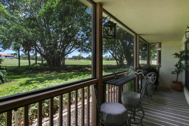 a view of a porch with furniture and garden