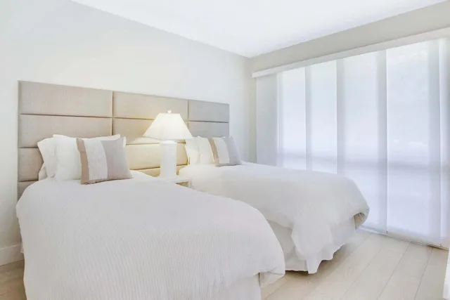 a bedroom with a bed and a night stand