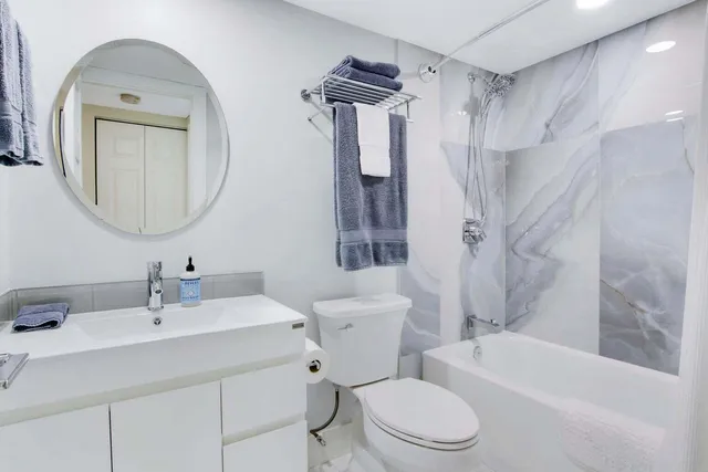 a bathroom with a toilet sink and shower