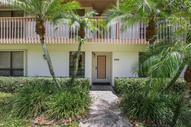 a front view of a house with plants