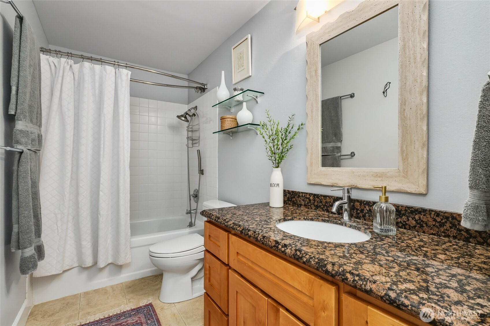 10414 Southwest 110th Street Vashon, WA 98070 - Photo 22 of 37 a bathroom with a granite countertop sink toilet and shower