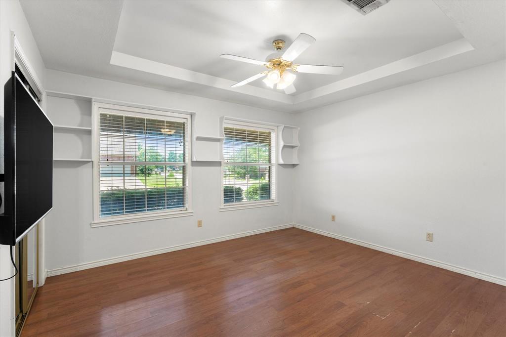410 Etheridge Road Canton, TX 75103 - Photo 14 of 22 Unfurnished room with a raised ceiling, wood finished floors, ceiling fan, and baseboards
