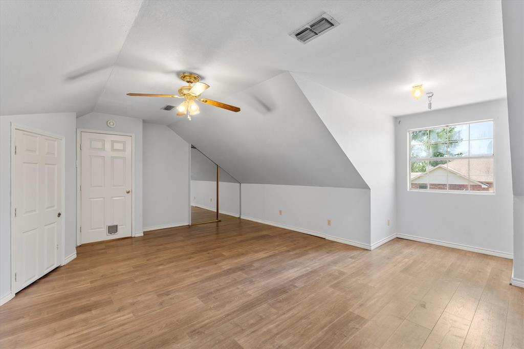 410 Etheridge Road Canton, TX 75103 - Photo 19 of 22 Additional living space featuring ceiling fan, vaulted ceiling, light wood-style flooring, and baseboards